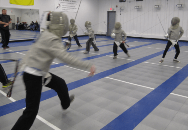 Youth fencers practicing footwork at FAB summer camp